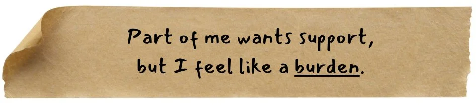 A torn brown paper with the handwritten message, "Part of me wants support, but I feel like a burden."