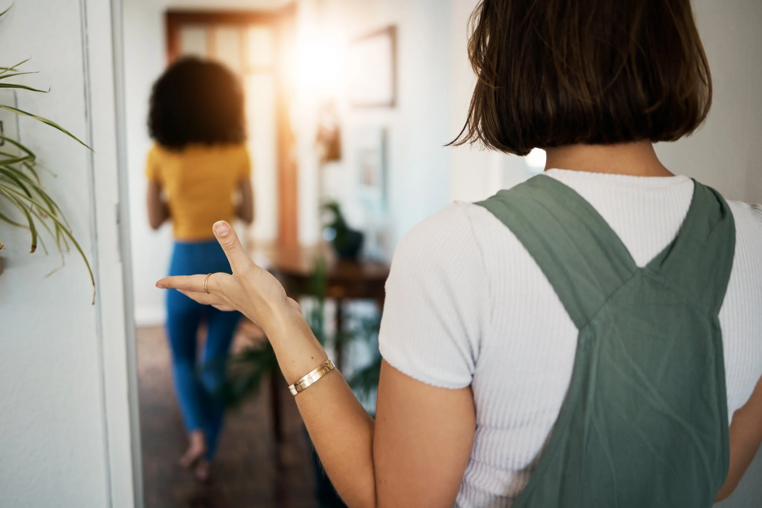 A Chicago woman with short brown hair appears frustrated and points towards her partner, another woman who is walking away.