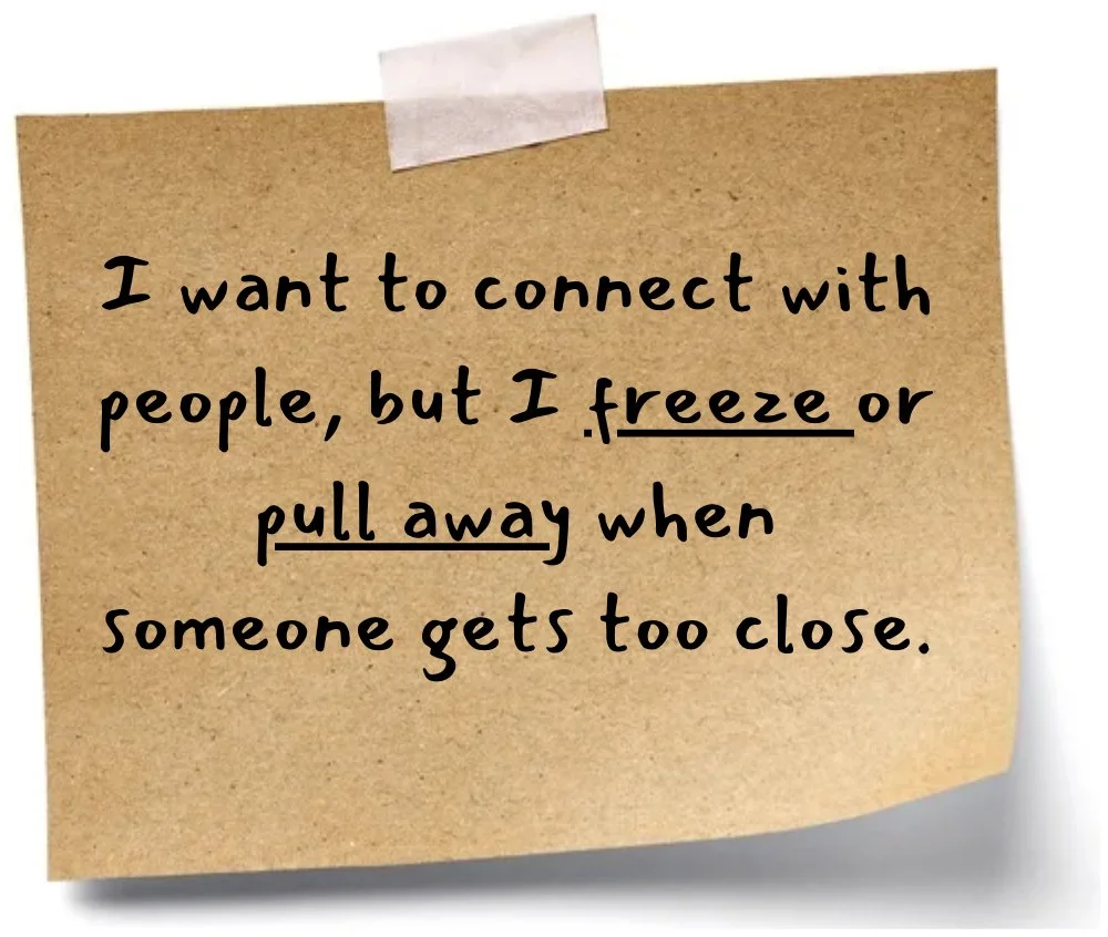 A brown sticky note attached with pink tape, with black handwritten text that reads: "I want to connect with people, but I freeze or pull away when someone gets too close."