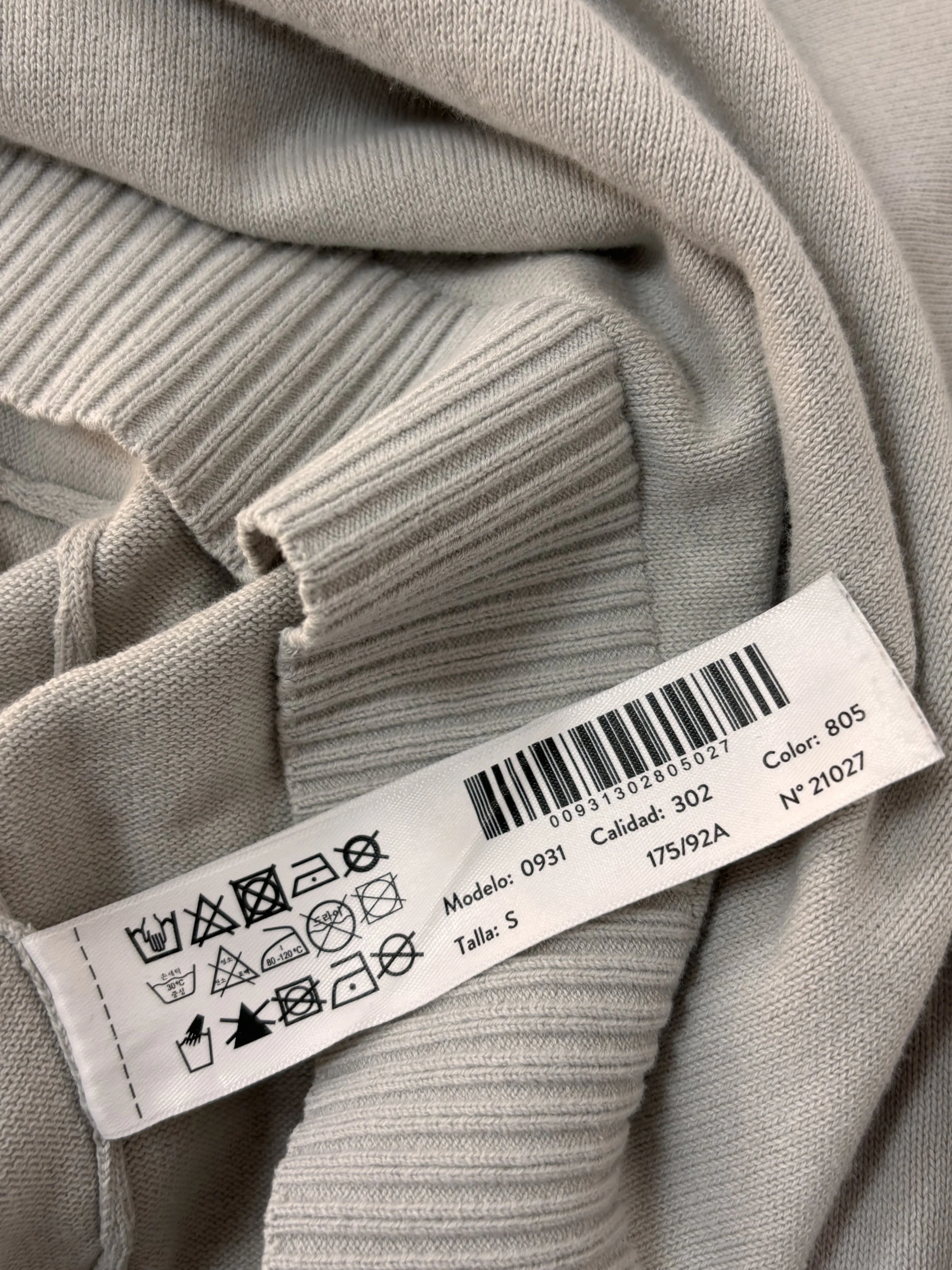 Close-up of Massimo Dutti ice green fine knit sweater showing soft knit texture and ribbed cuffs.