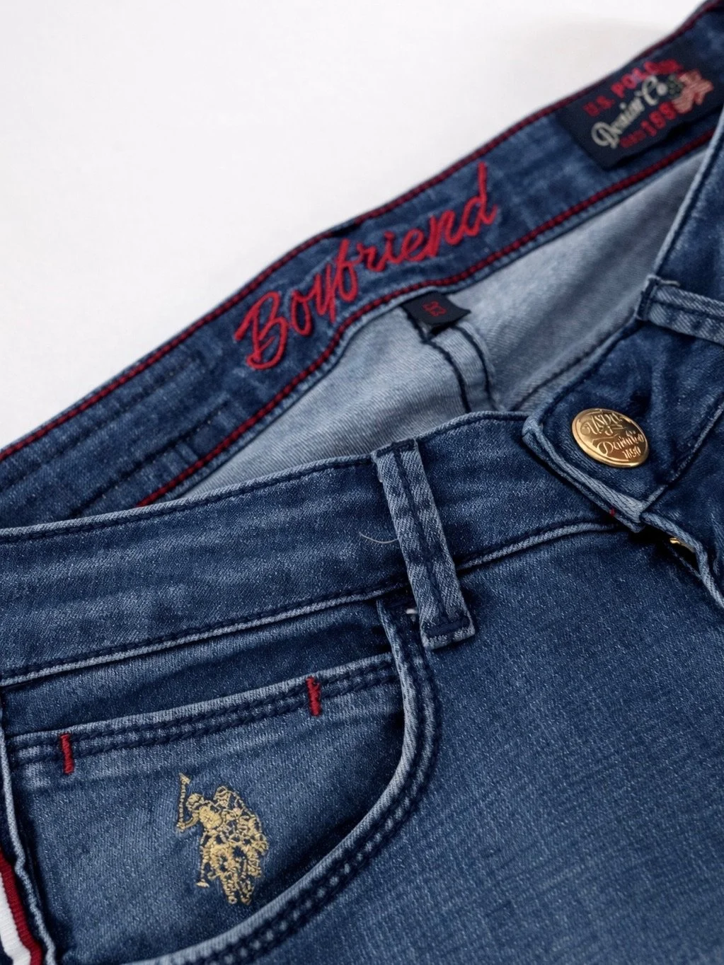 U.S. Polo Assn. Boyfriend jeans close-up with embroidered waistband detail and side stripe denim