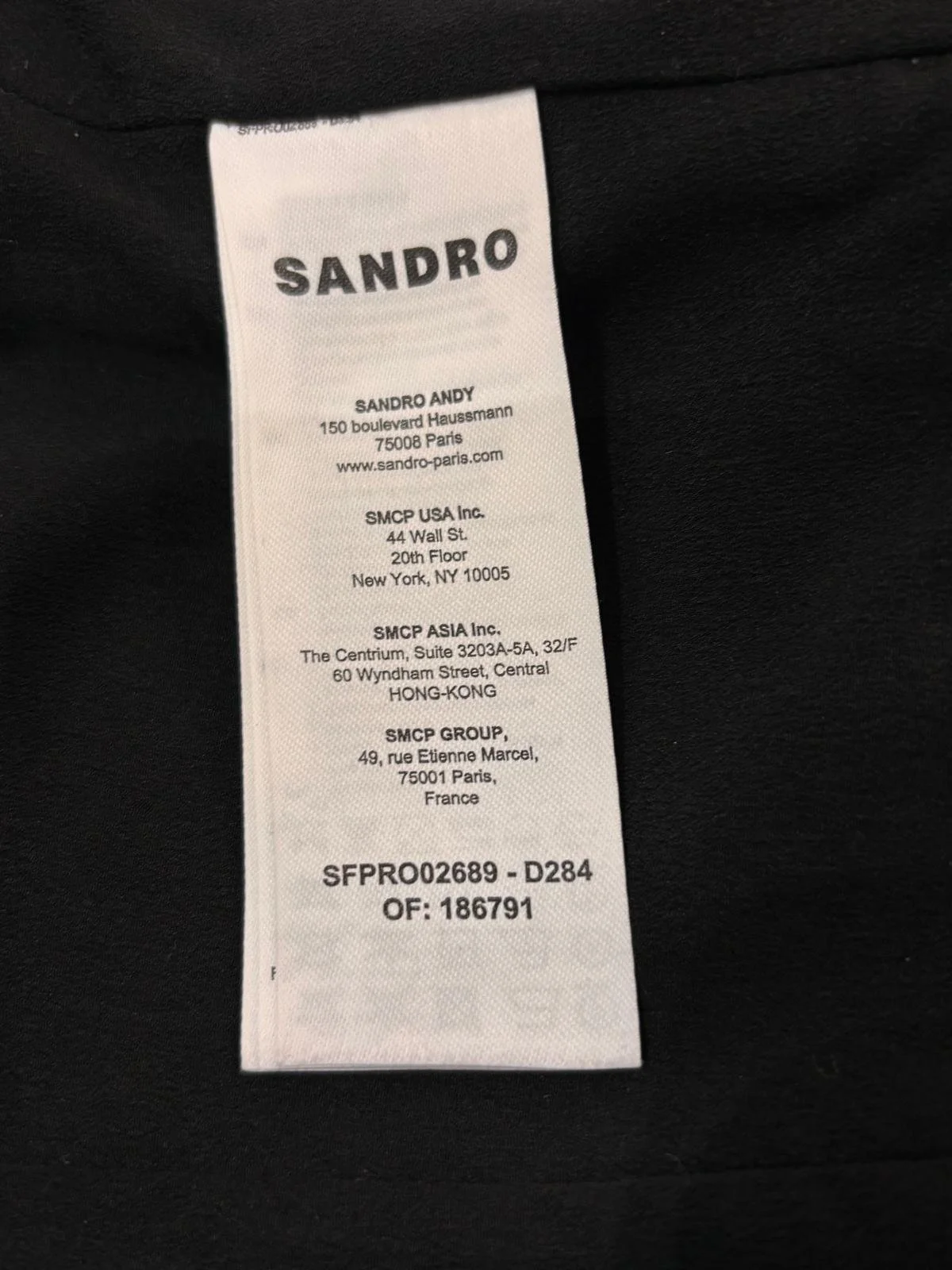 Sandro brand label inside women’s tweed mini dress, authentic designer clothing tag