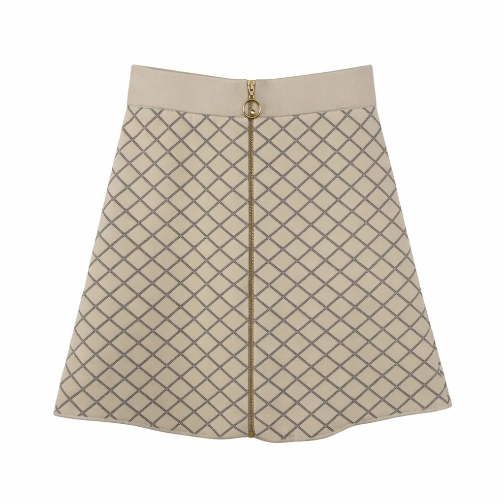 Sandro beige tweed mini skirt with diamond pattern and front zip detail, photographed on a white background – pre-loved luxury fashion curated by Norée Thrift de Lux.