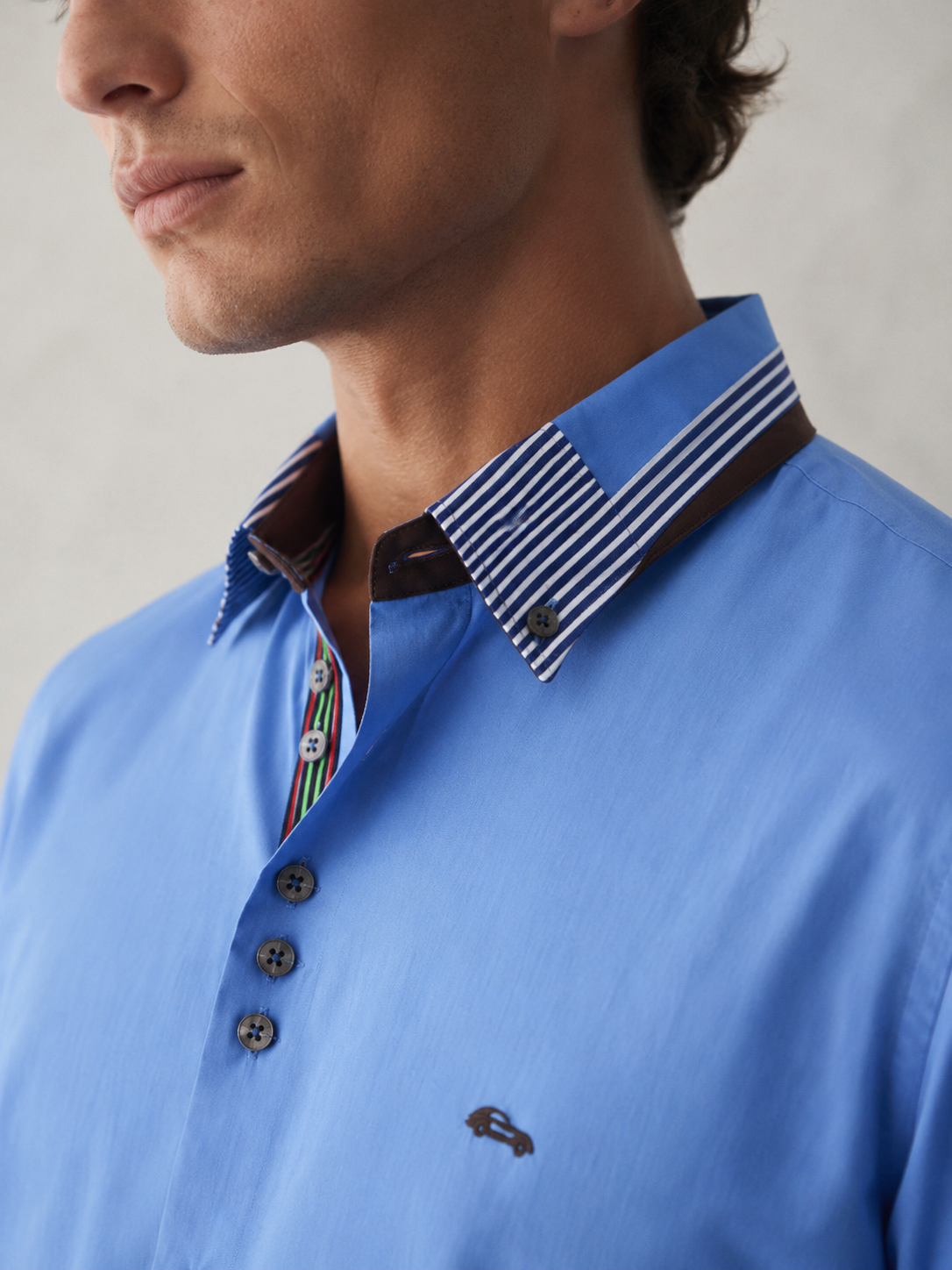 Dario Beltran light blue shirt with striped collar and signature details