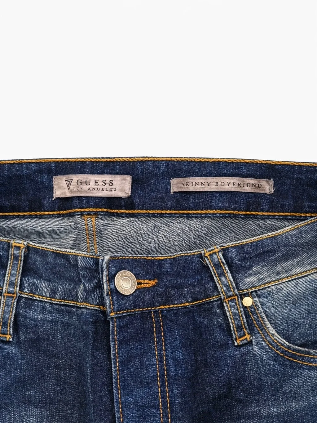 Guess Los Angeles Skinny Boyfriend jeans label and button close-up with vintage wash denim