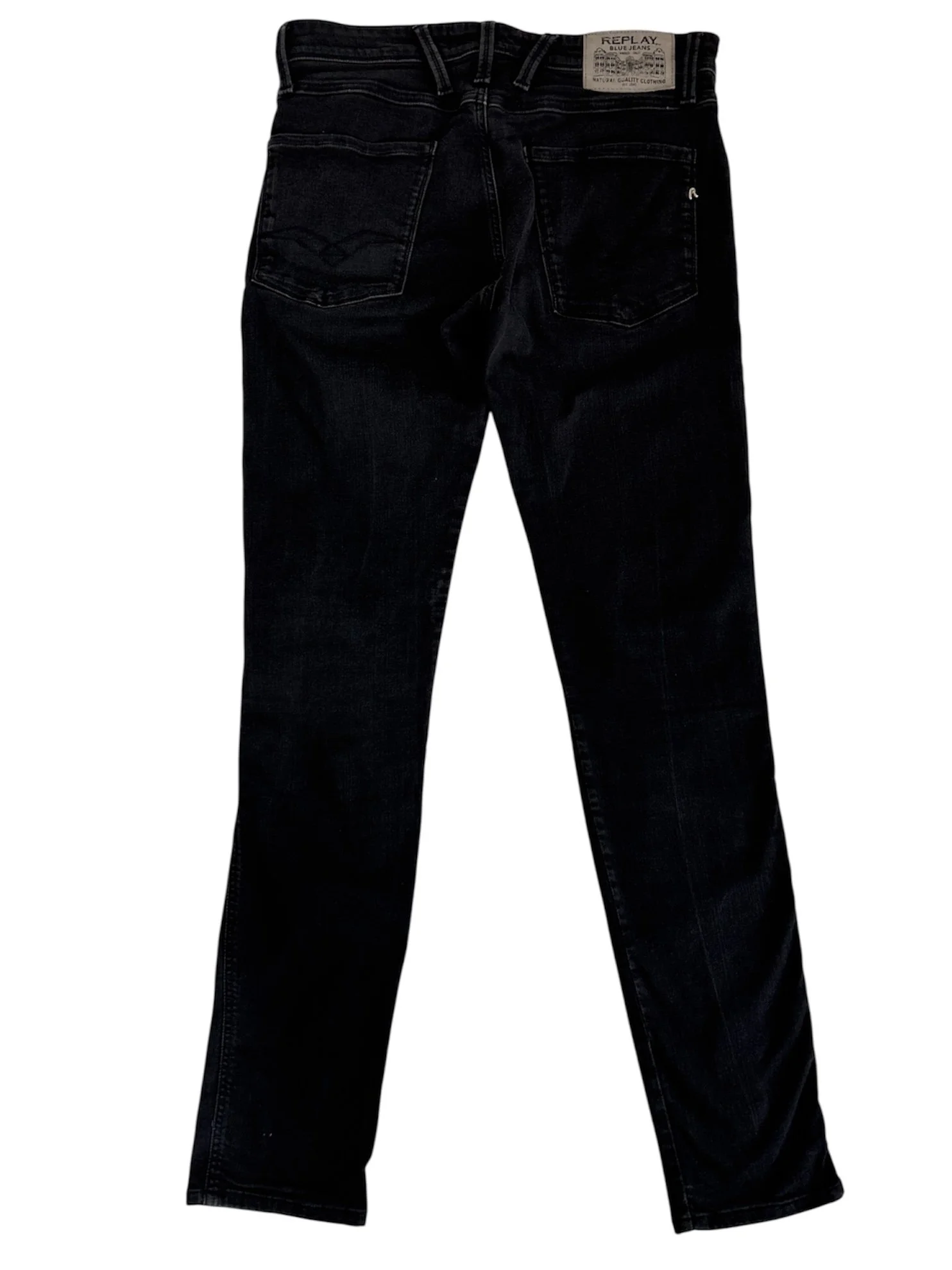 Close-up of Replay logo detail on black men’s designer jeans with premium dark wash denim texture