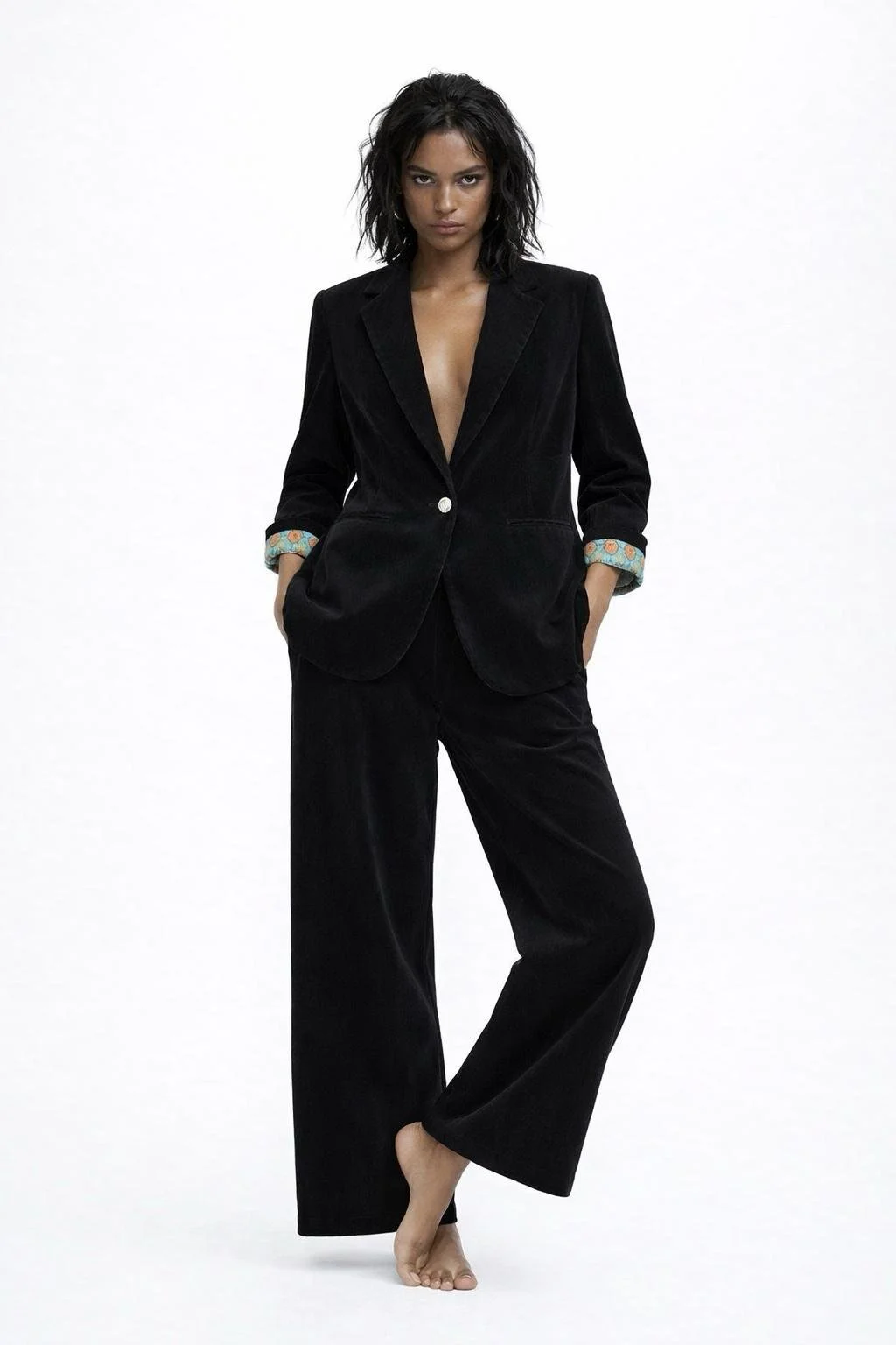 Black velvet women’s suit with wide-leg trousers and relaxed blazer