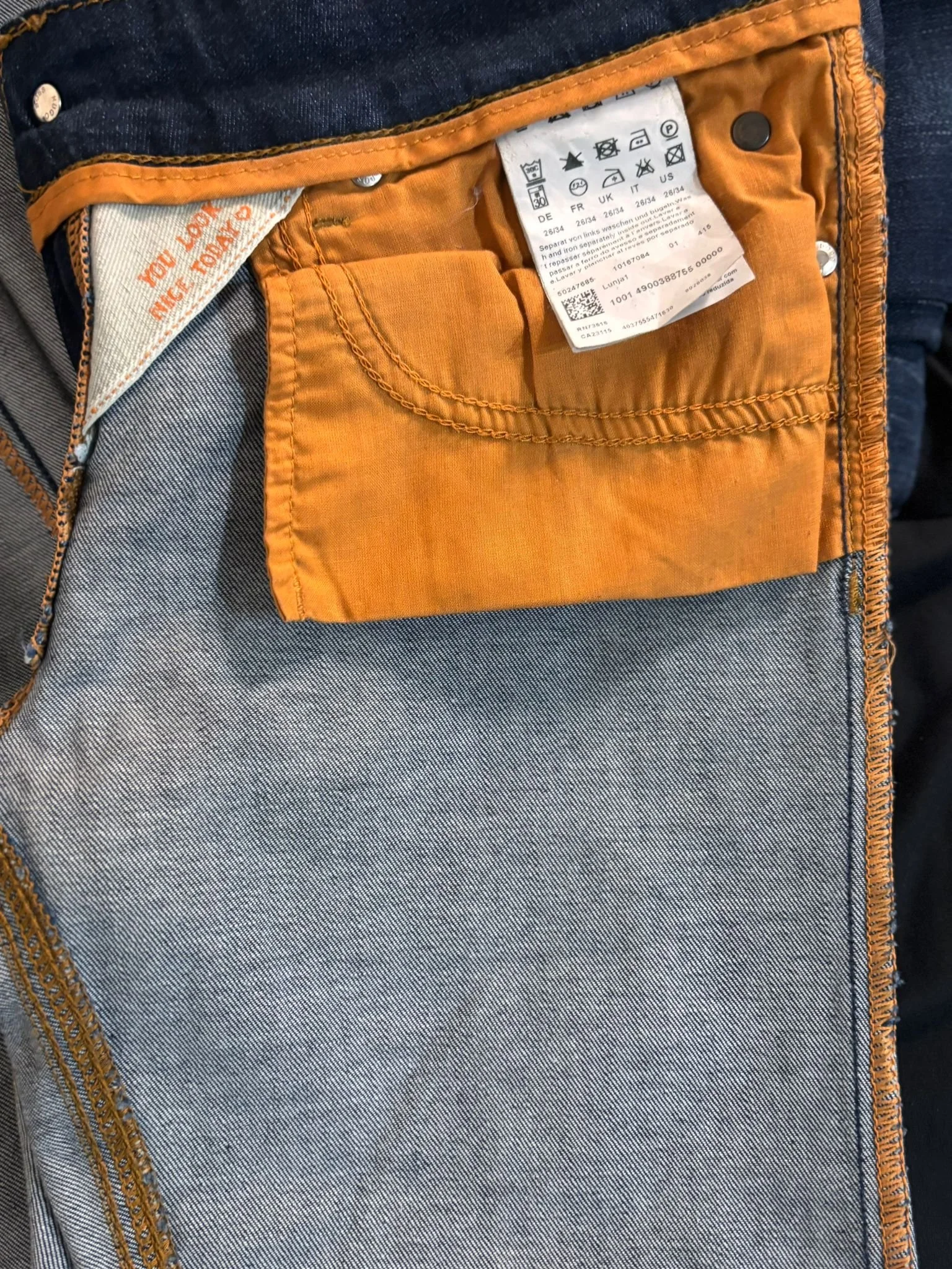 Hugo Boss Orange luxury designer jeans interior detail, care label and inner pocket, premium pre-owned denim, Virtual Preview Available