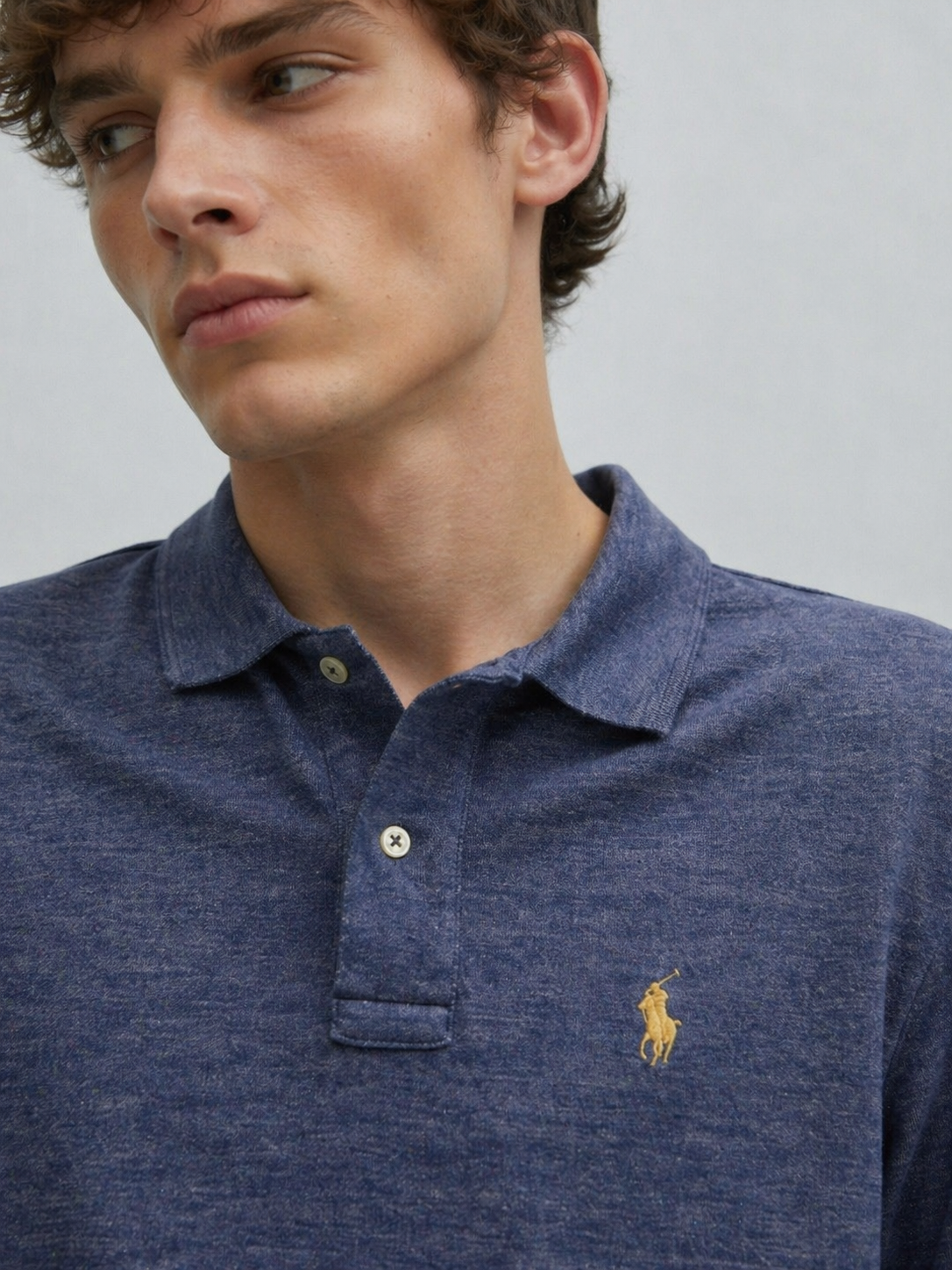 Polo Ralph Lauren blue polo shirt collar detail cotton fabric texture close-up