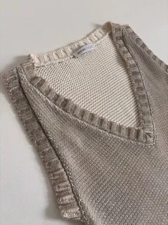 Close-up of See by Chloé beige metallic knit vest with textured fabric and ribbed V-neck detailing luxury designer knitwear