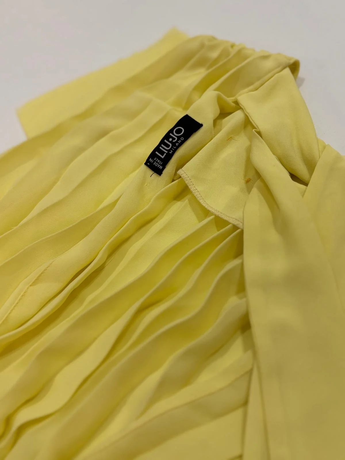 LIU JO Milano original brand label close-up on yellow chiffon dress, authentic pre-owned designer clothing