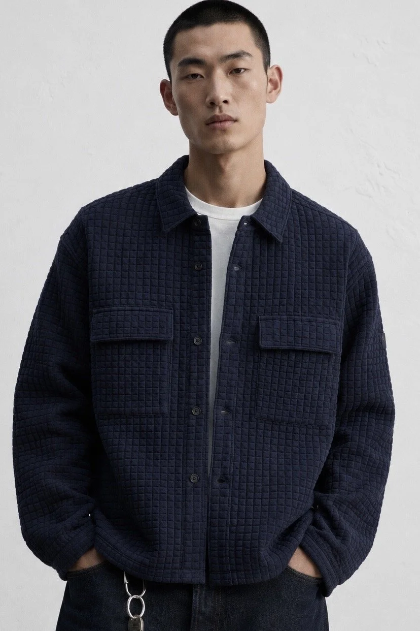 Cavallaro Napoli navy quilted overshirt styled on model with textured fabric, chest pockets and modern smart casual fit