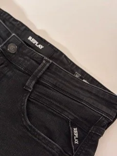 Replay black slim fit men’s jeans close-up with branded pocket detail and faded dark denim finish