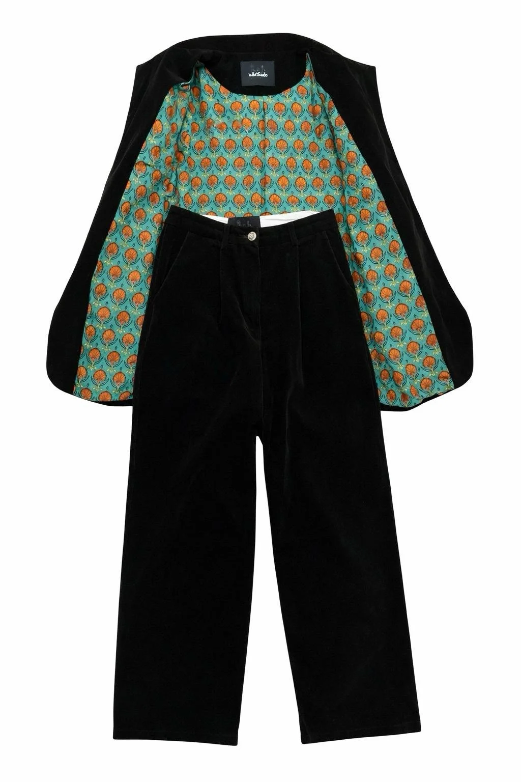 Black velvet blazer with green floral lining and wide-leg trousers