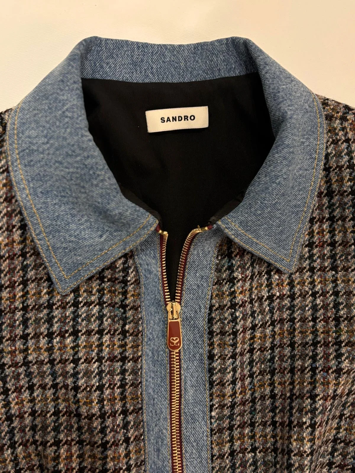 Close-up of Sandro denim collar and gold front zip on tweed mini dress, authentic designer detail