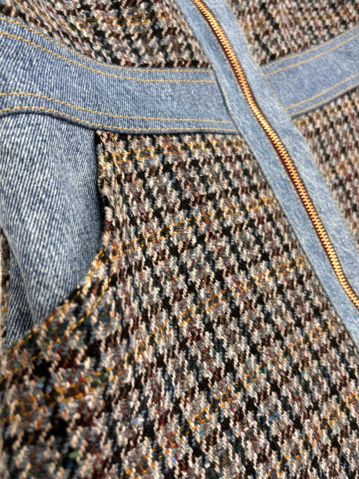Close-up of tweed fabric and gold zip on Sandro mini dress with denim trim, designer dress detail