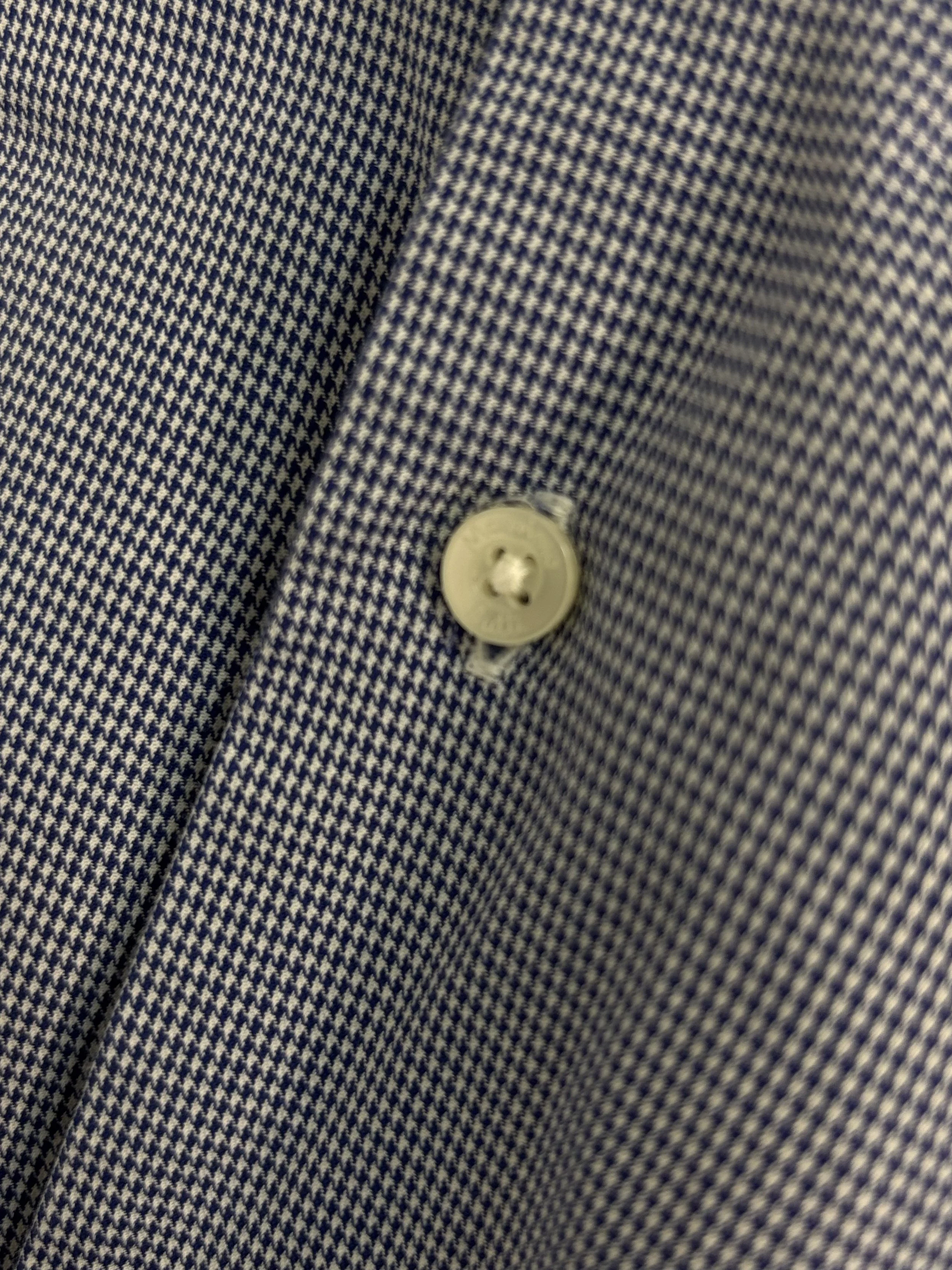 Close-up of Massimo Dutti blue micro-check cotton fabric and branded button detail