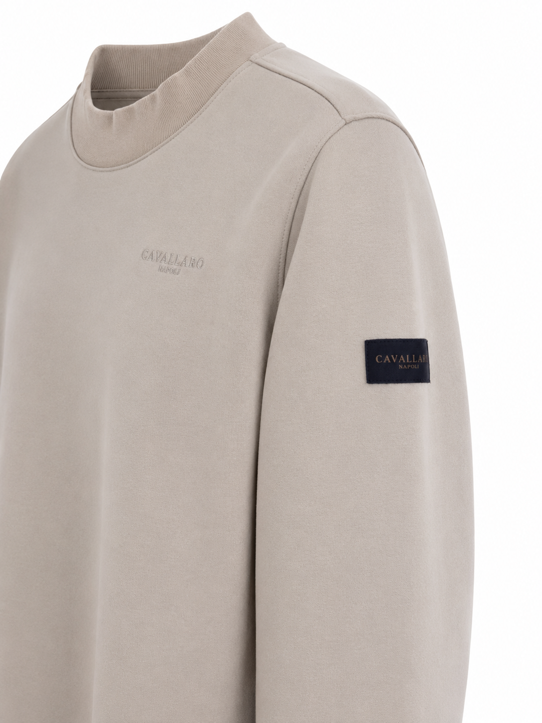 Close-up of Cavallaro Napoli men’s cream beige sweatshirt featuring tonal embroidered chest logo, premium fabric and signature sleeve patch detail.