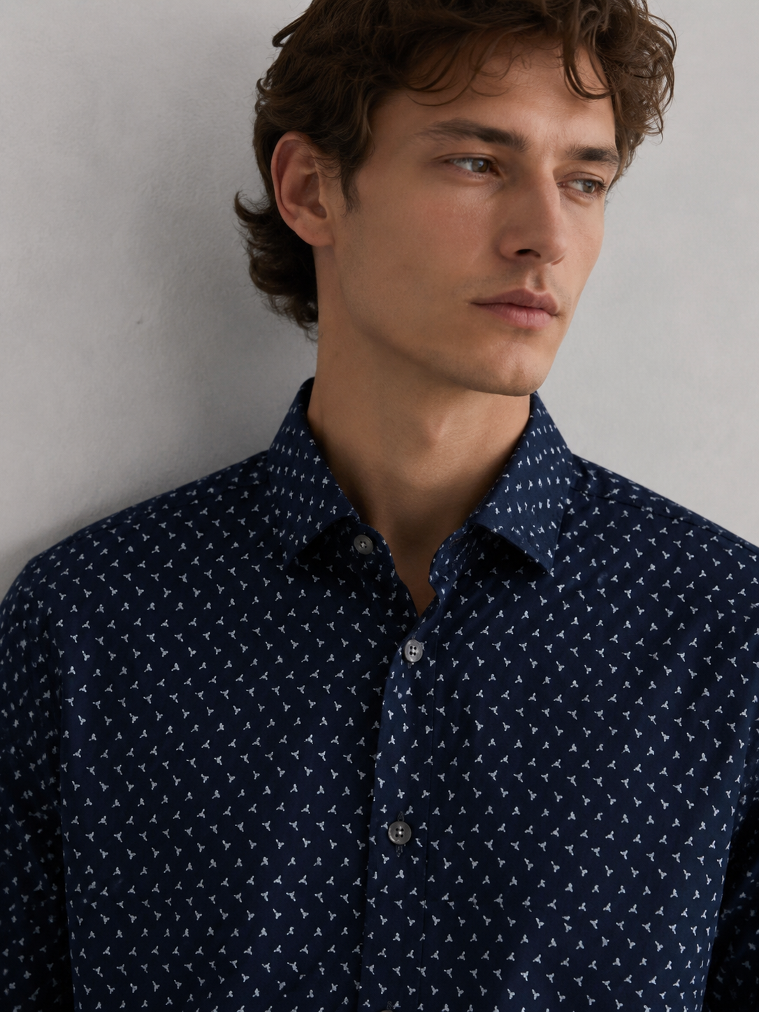 Close-up of Ted Baker London men’s navy designer shirt featuring white geometric print, classic collar and premium cotton fabric.