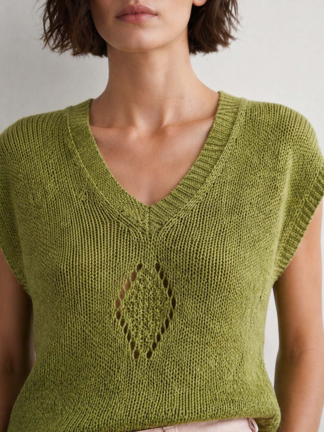 Close-up of Gerry Weber lime green knit vest with V-neck and decorative open knit detail