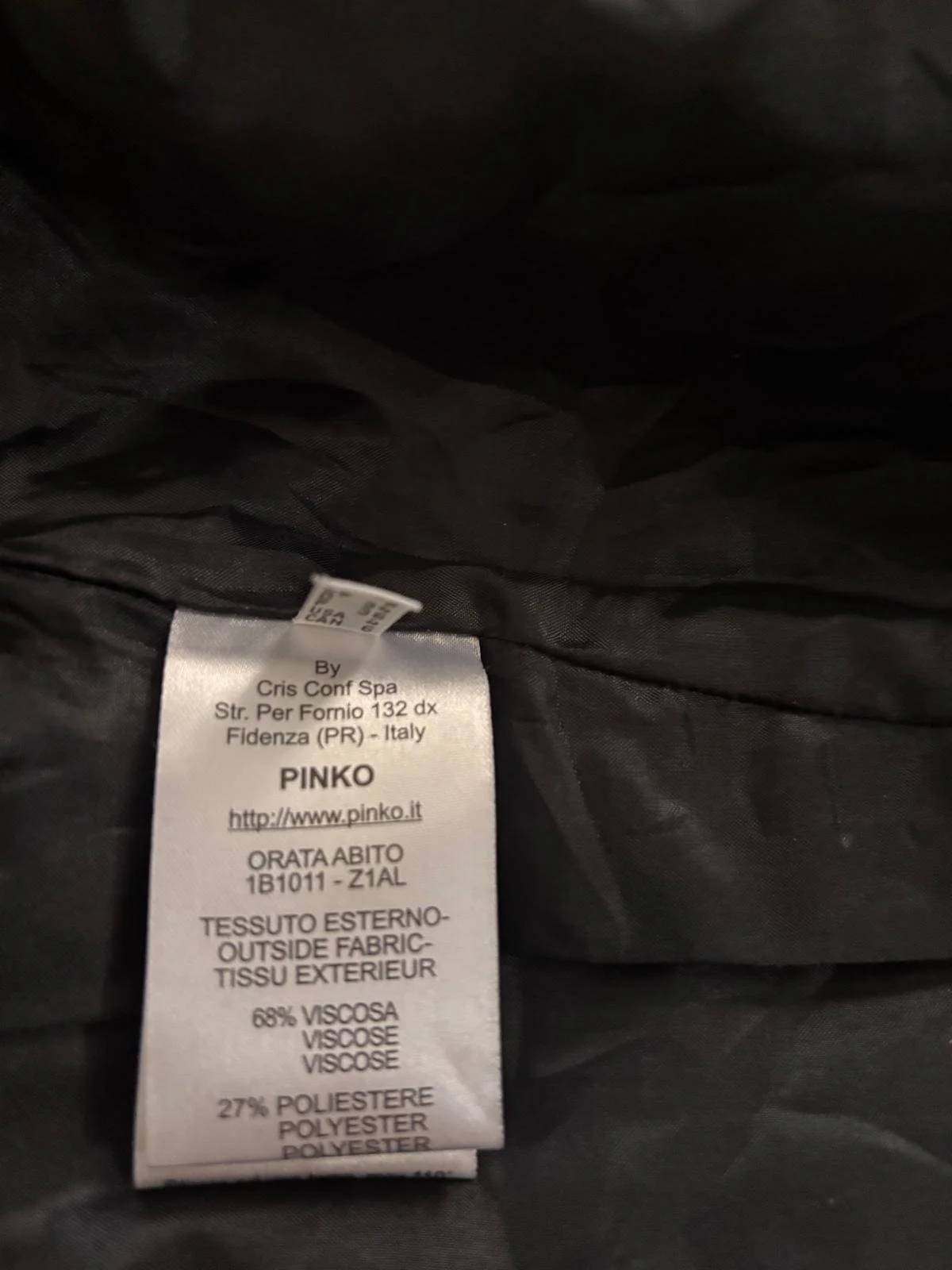 Pinko dress fabric composition label showing viscose and polyester blend, made in Italy