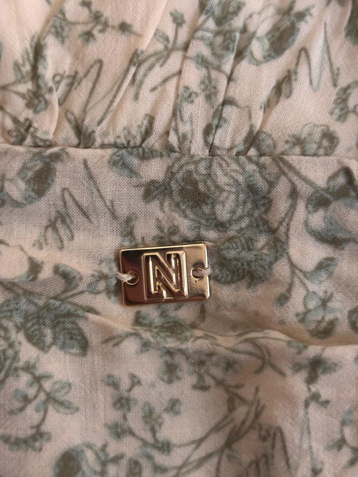 NIKKIE metal logo detail on floral dress waistband