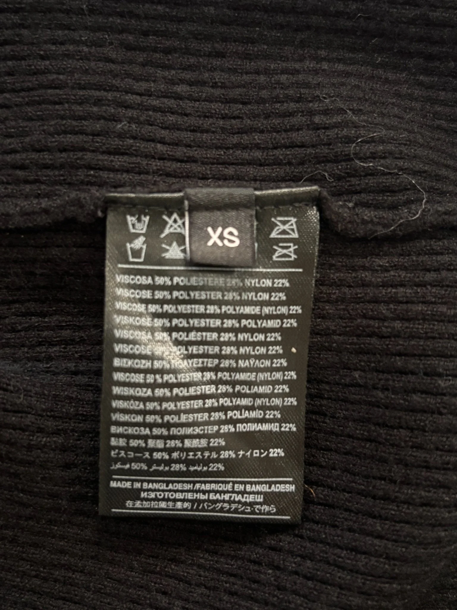 John Richmond black turtleneck sweater material and composition tag close-up