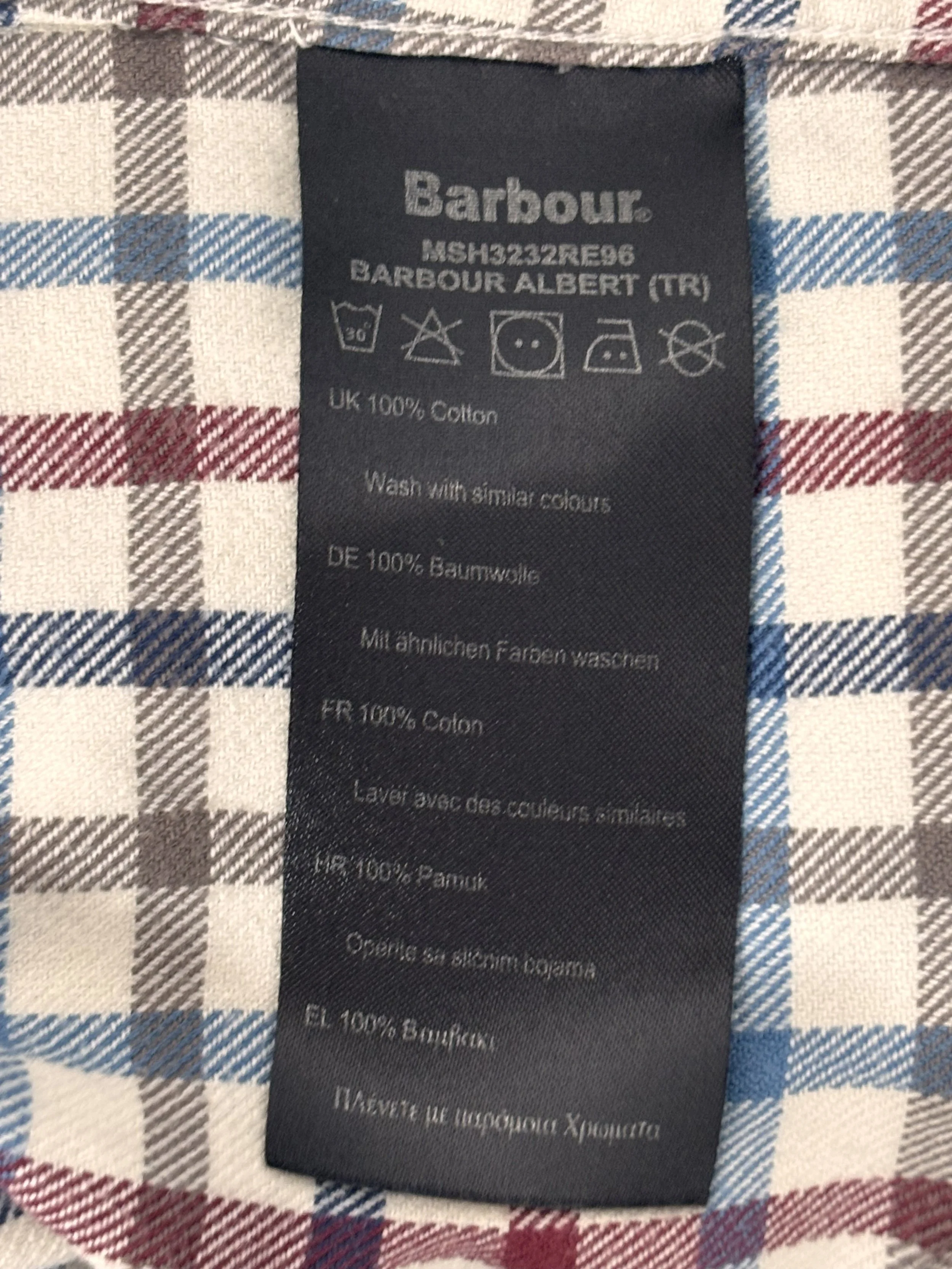 Original Barbour care label showing 100% cotton fabric and garment care instructions.