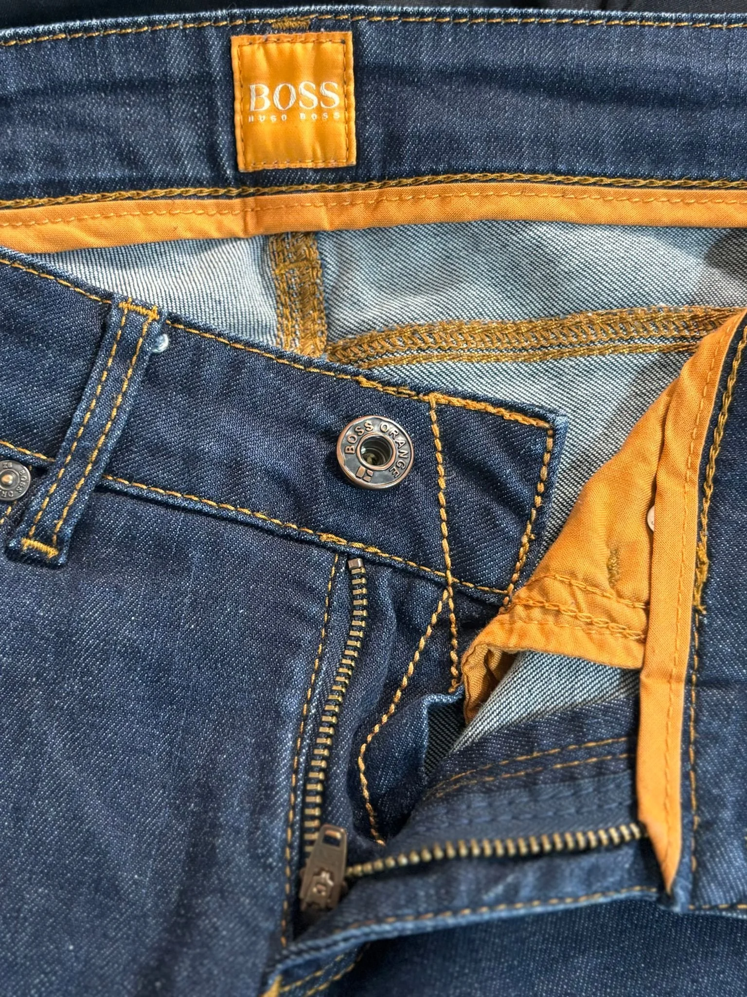 Hugo Boss Orange luxury designer jeans hardware detail, branded button and zipper, premium denim construction, Virtual Preview Available