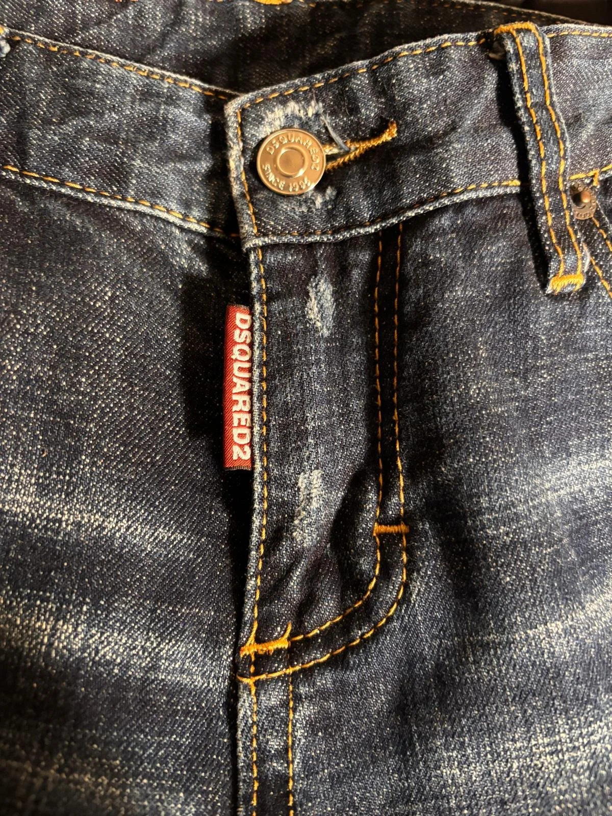 Dsquared2 luxury designer jeans detail, metal button and distressed denim texture, premium Italian craftsmanship, designer denim close-up, Virtual Preview Available