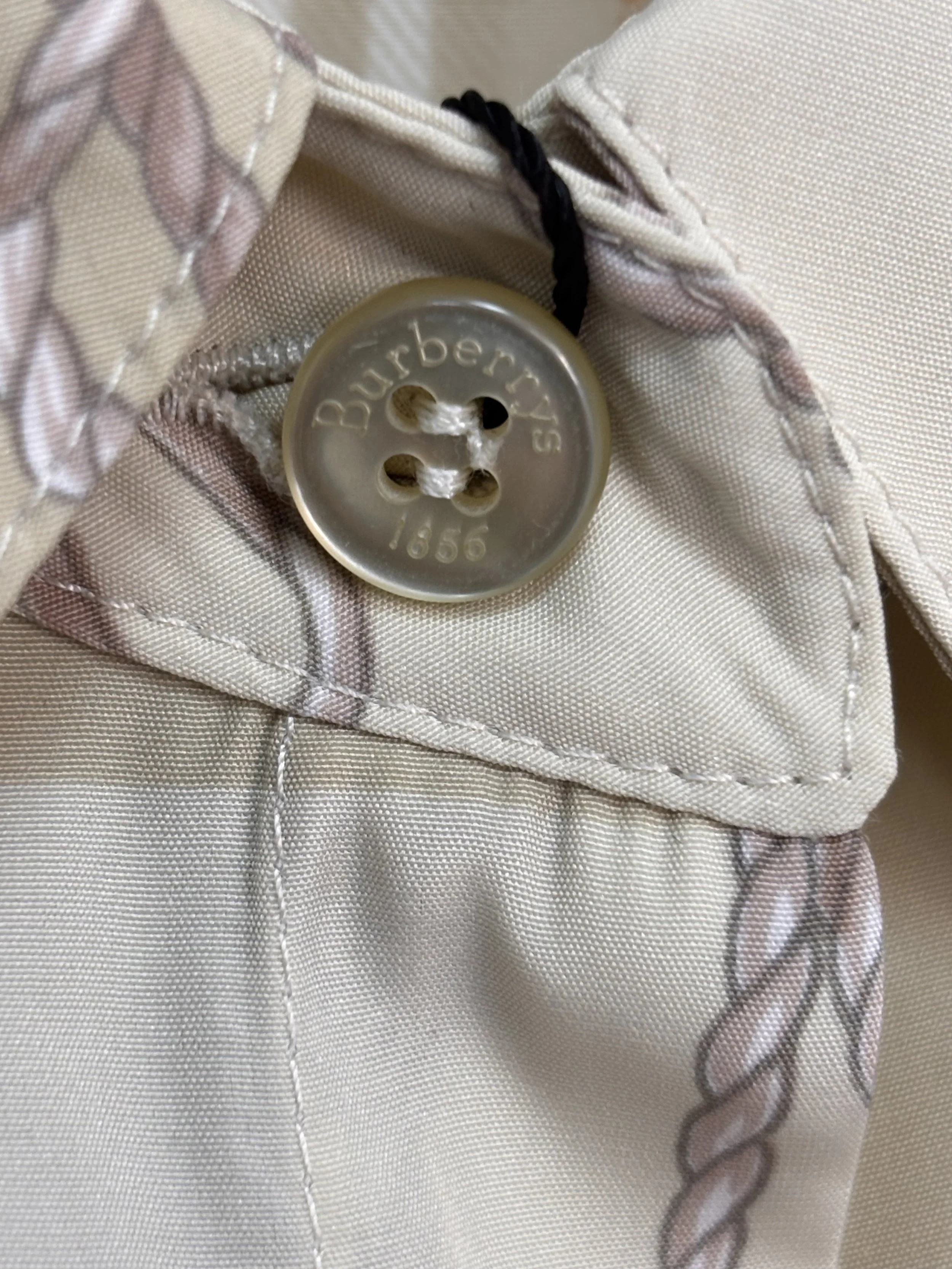 Burberrys engraved button authentic luxury detail close-up