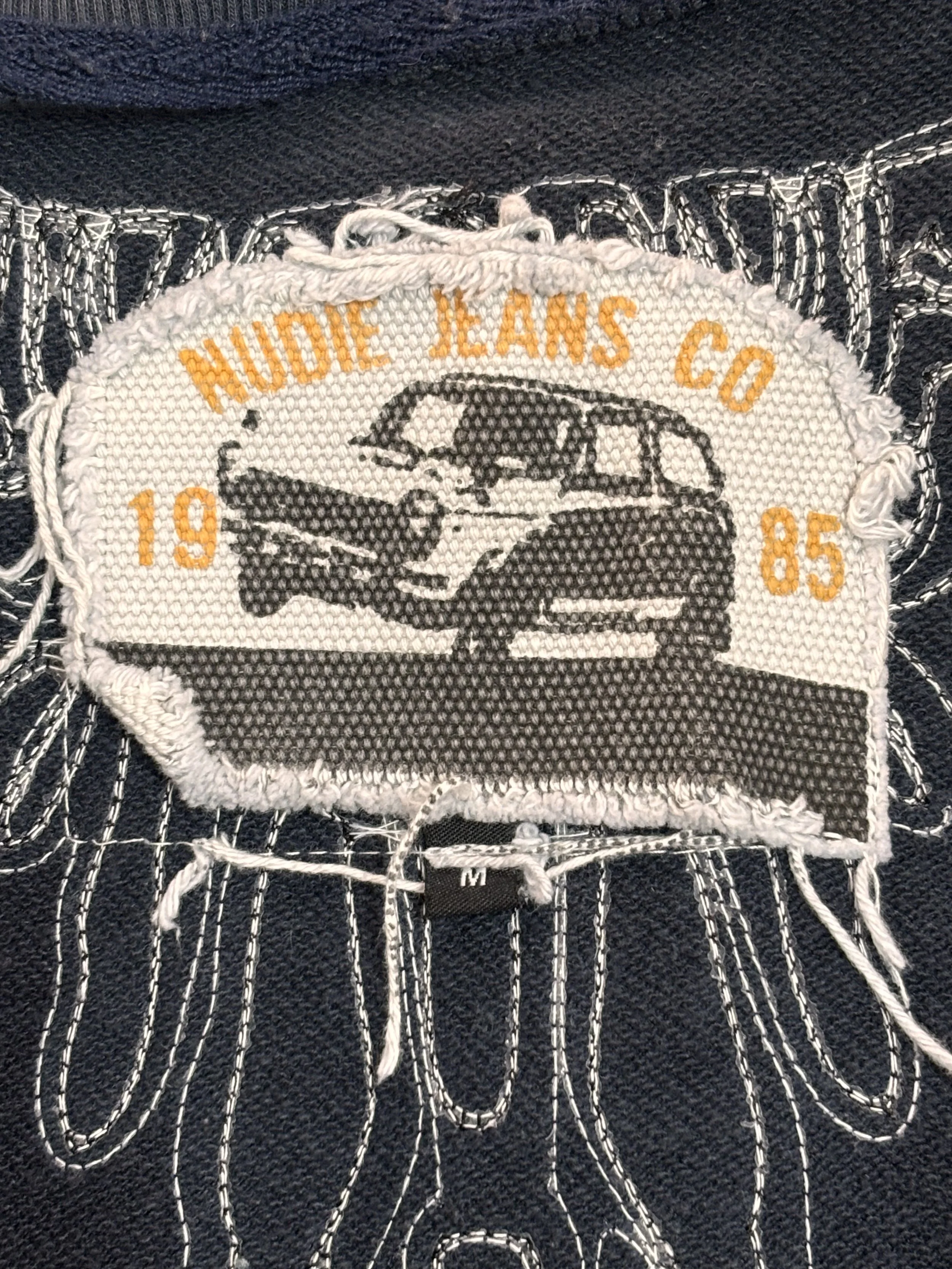 Nudie Jeans Co heritage logo label close-up