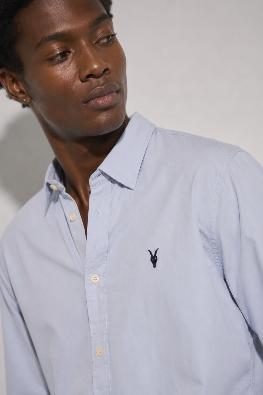 AllSaints Ramskull logo light blue shirt close-up