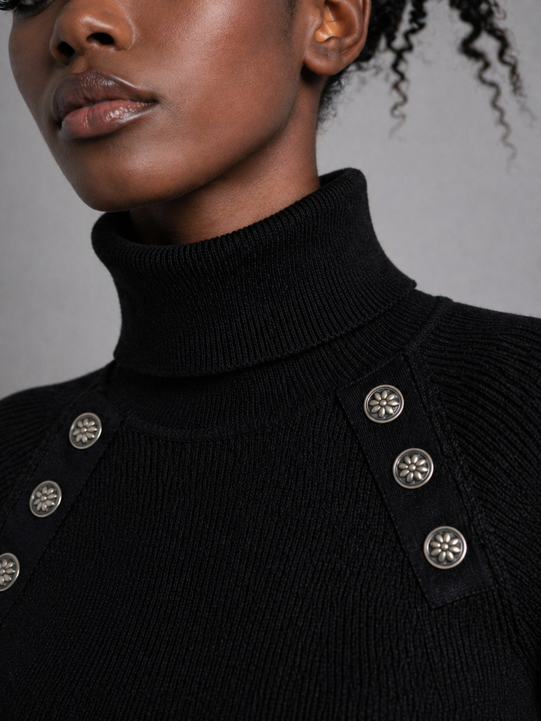 Close-up of John Richmond black ribbed turtleneck sweater with silver-tone floral buttons