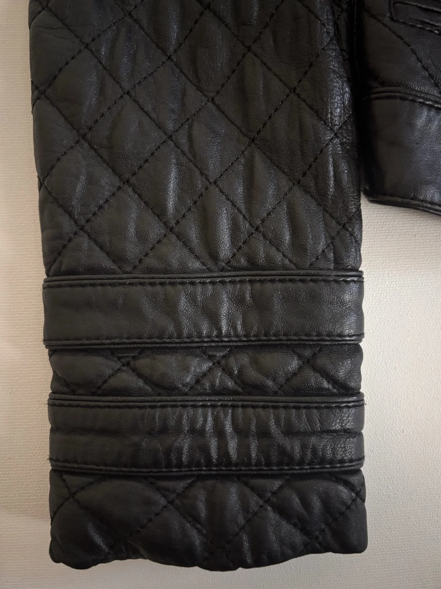 Intuition Paris black quilted leather jacket sleeve detail with stitched panel design