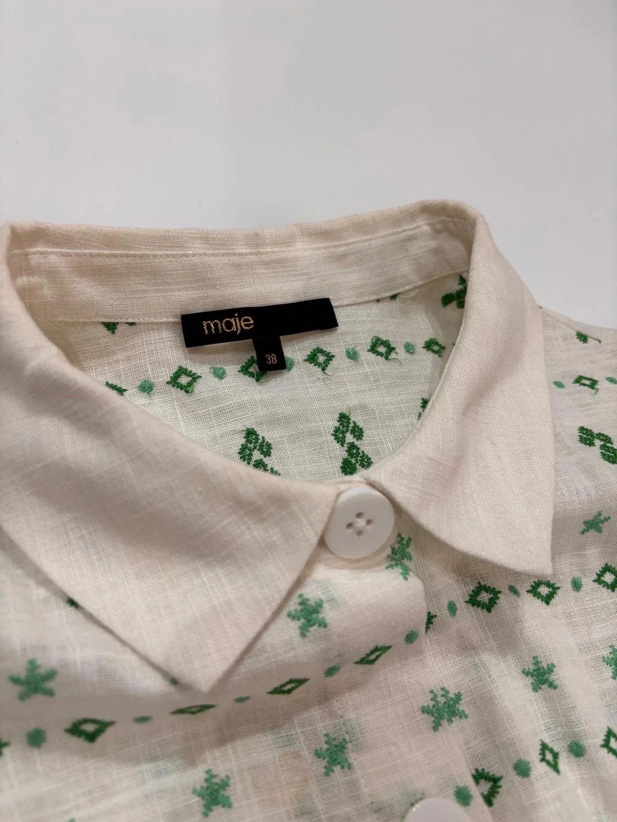Maje white and green ramie blend dress collar close-up with button detail and size label