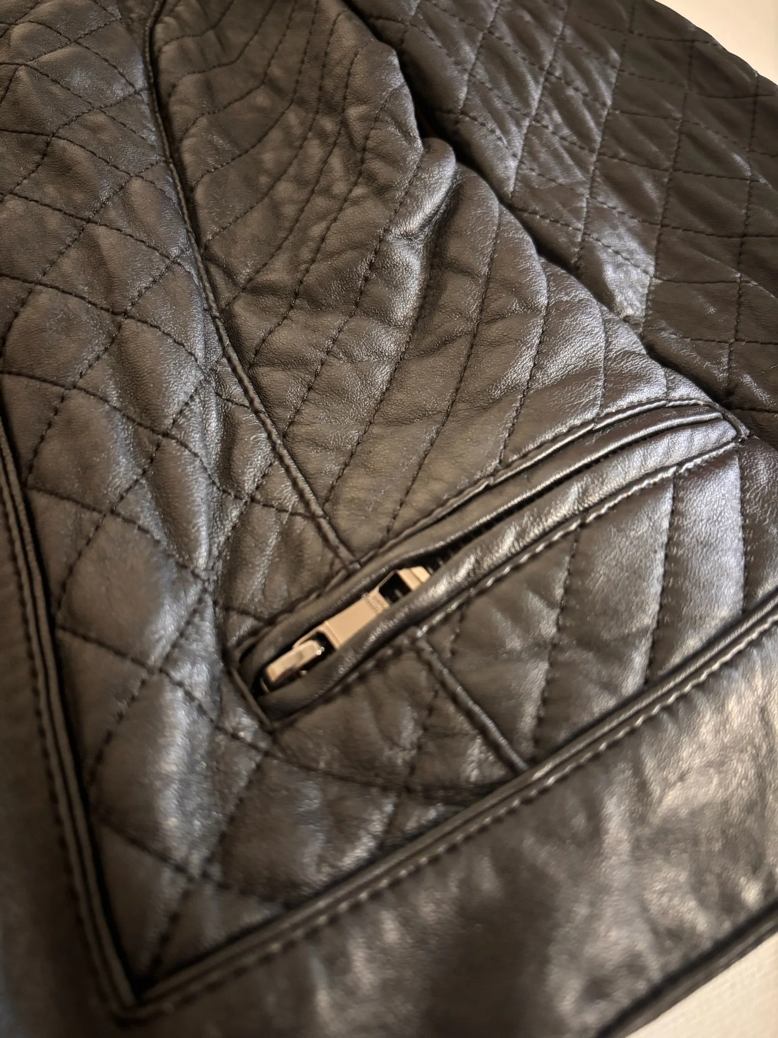 Intuition Paris black lamb leather jacket zip pocket close-up with quilted stitching detail