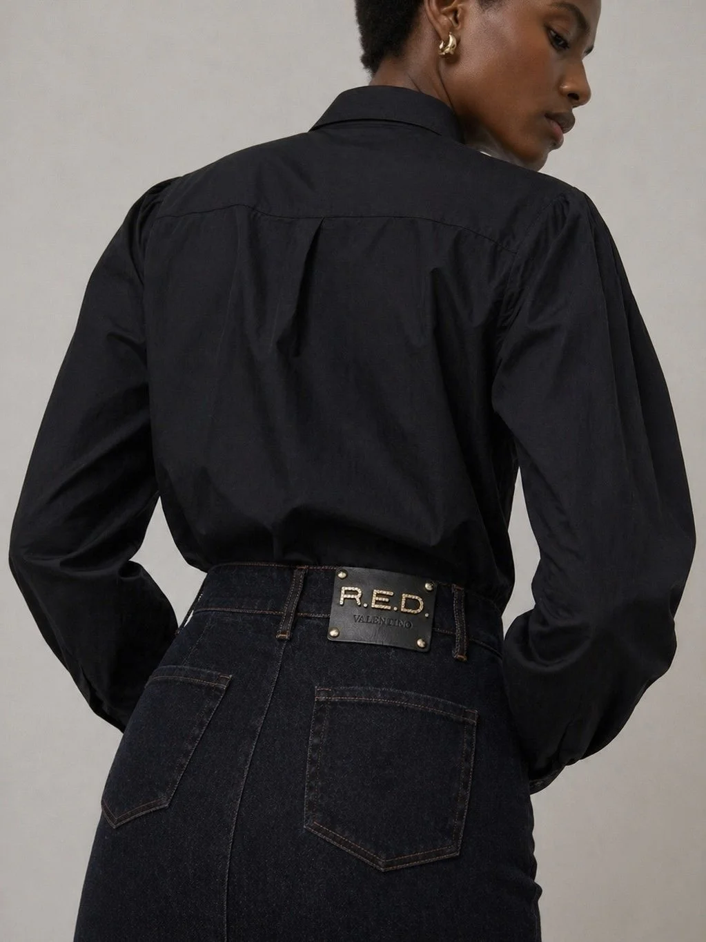 R.E.D. Valentino denim skirt back view with designer logo plaque