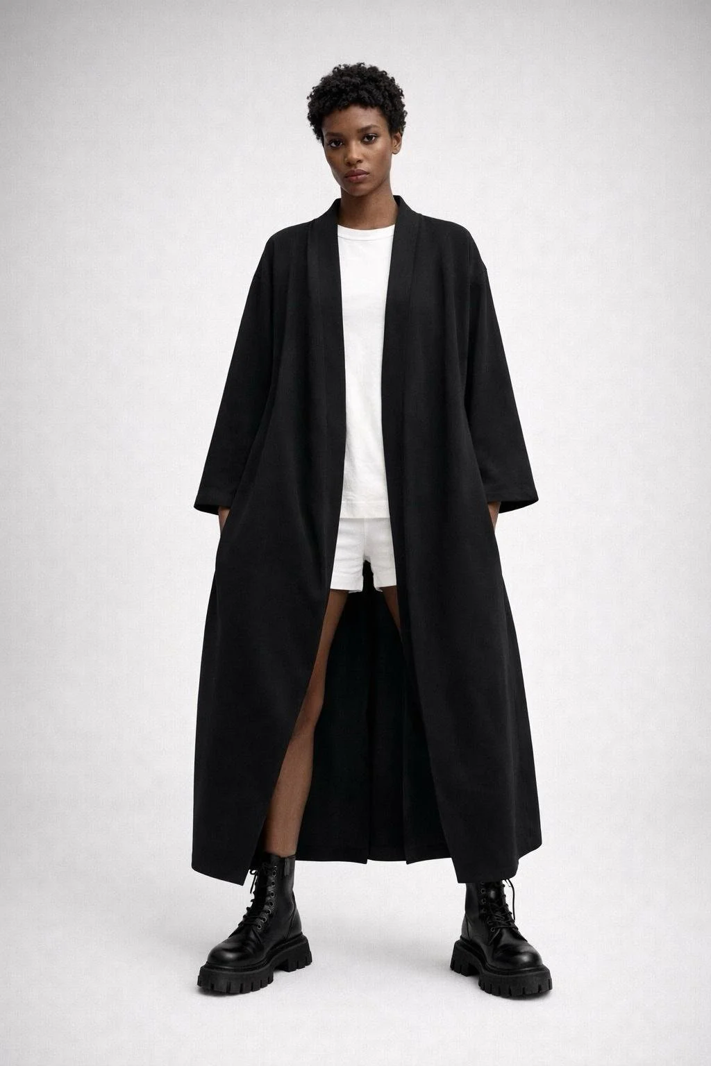 Model wearing black kimono-style cardigan by Wendy Trendy, relaxed oversized fit