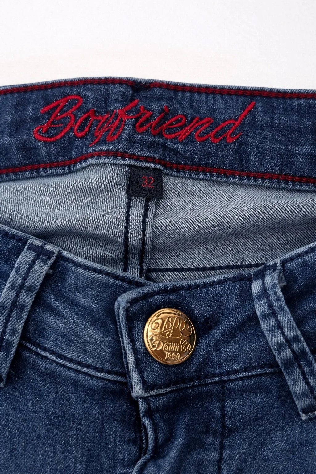 U.S. Polo Assn. Boyfriend jeans waistband close-up with embroidered logo and gold button