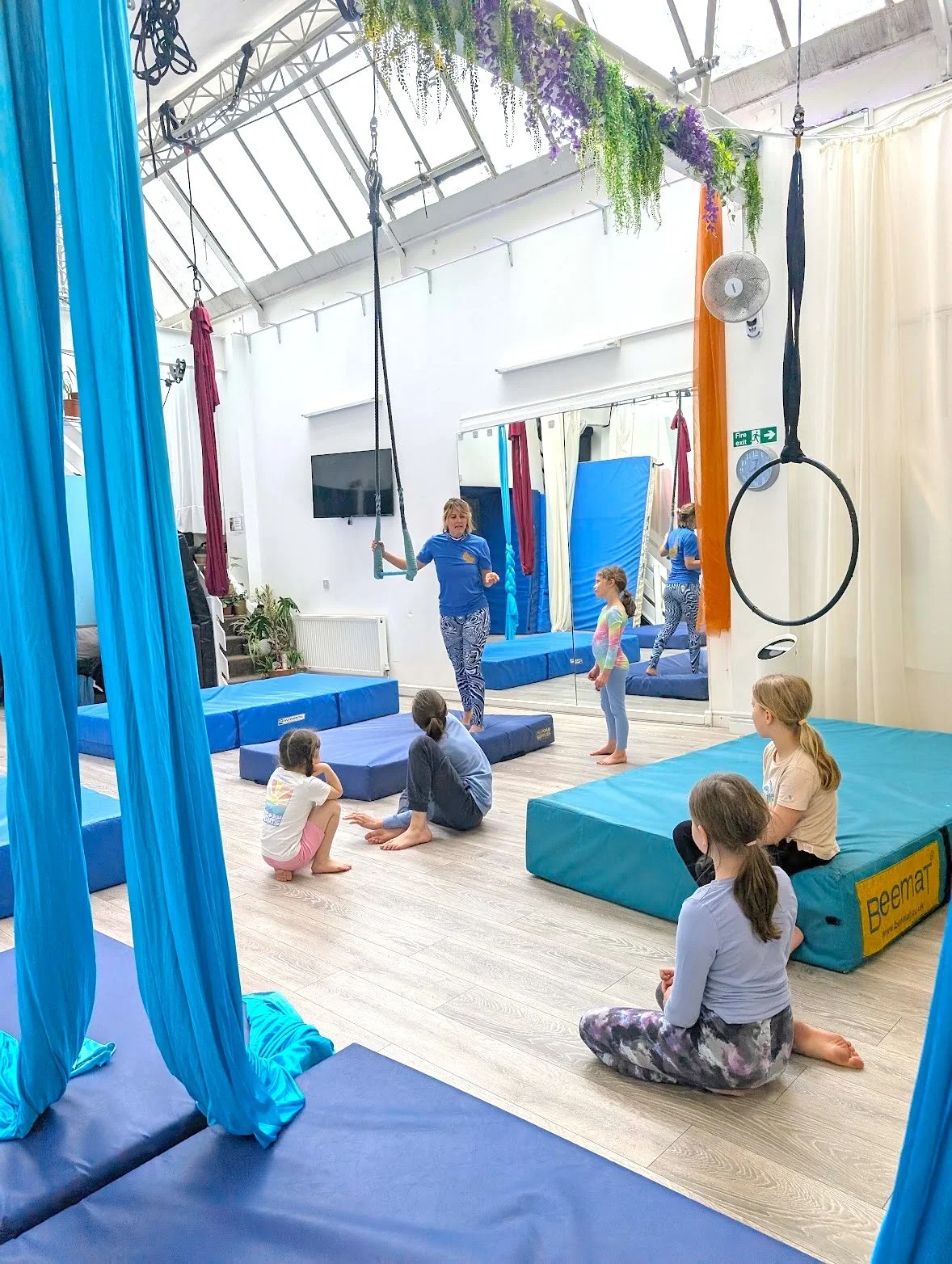 Children taking part in an aerial silks and circus class at Rebel Youth Circus in London, with professional aerial equipment and instructor-led training.