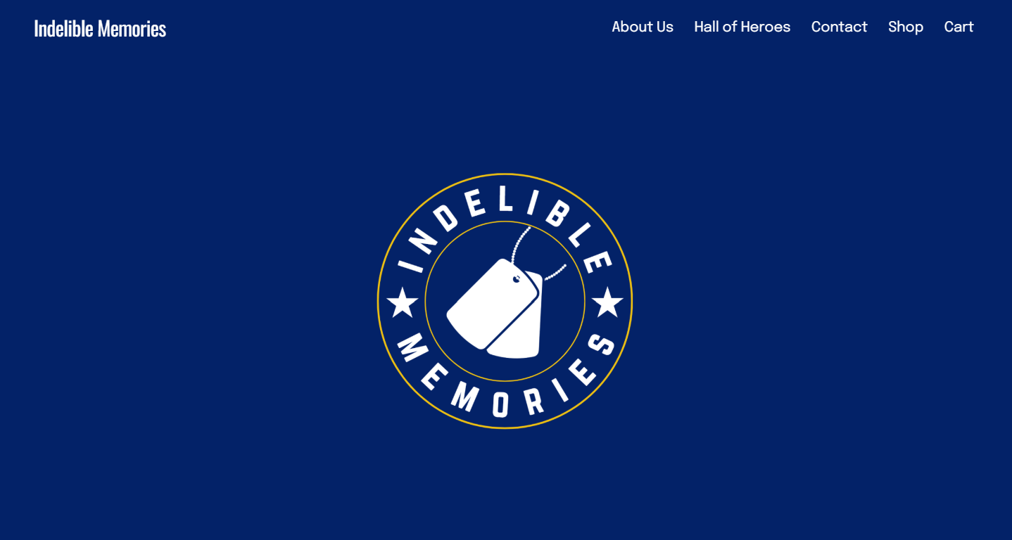 Website header with navy background, logo featuring two luggage tags and the text 'Indelible Memories,' and navigation links labeled 'About Us,' 'Hall of Heroes,' 'Contact,' 'Shop,' and 'Cart.'