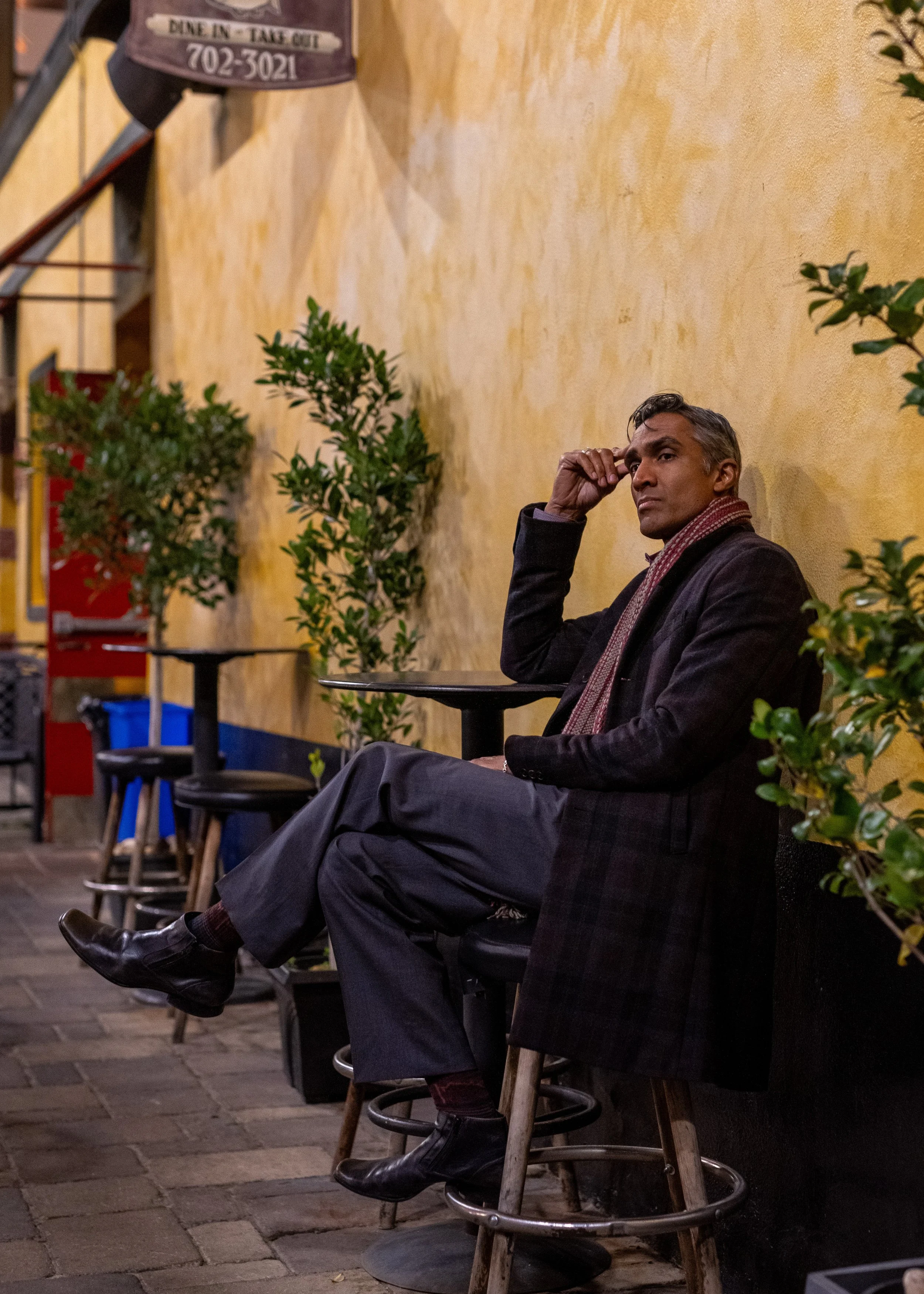 Dylan sitting at a midnight cafe dressed as a gentleman would and pondering the meaningless parts of life.