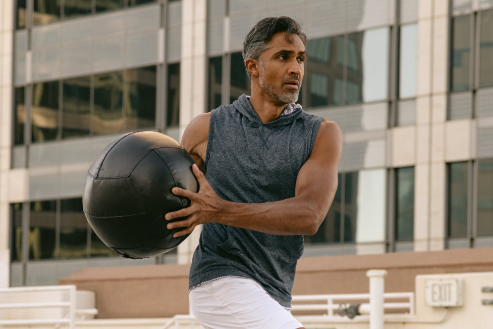 Dylan Jawahir Model Actor Exercising with Medicine Ball in Urban Environment