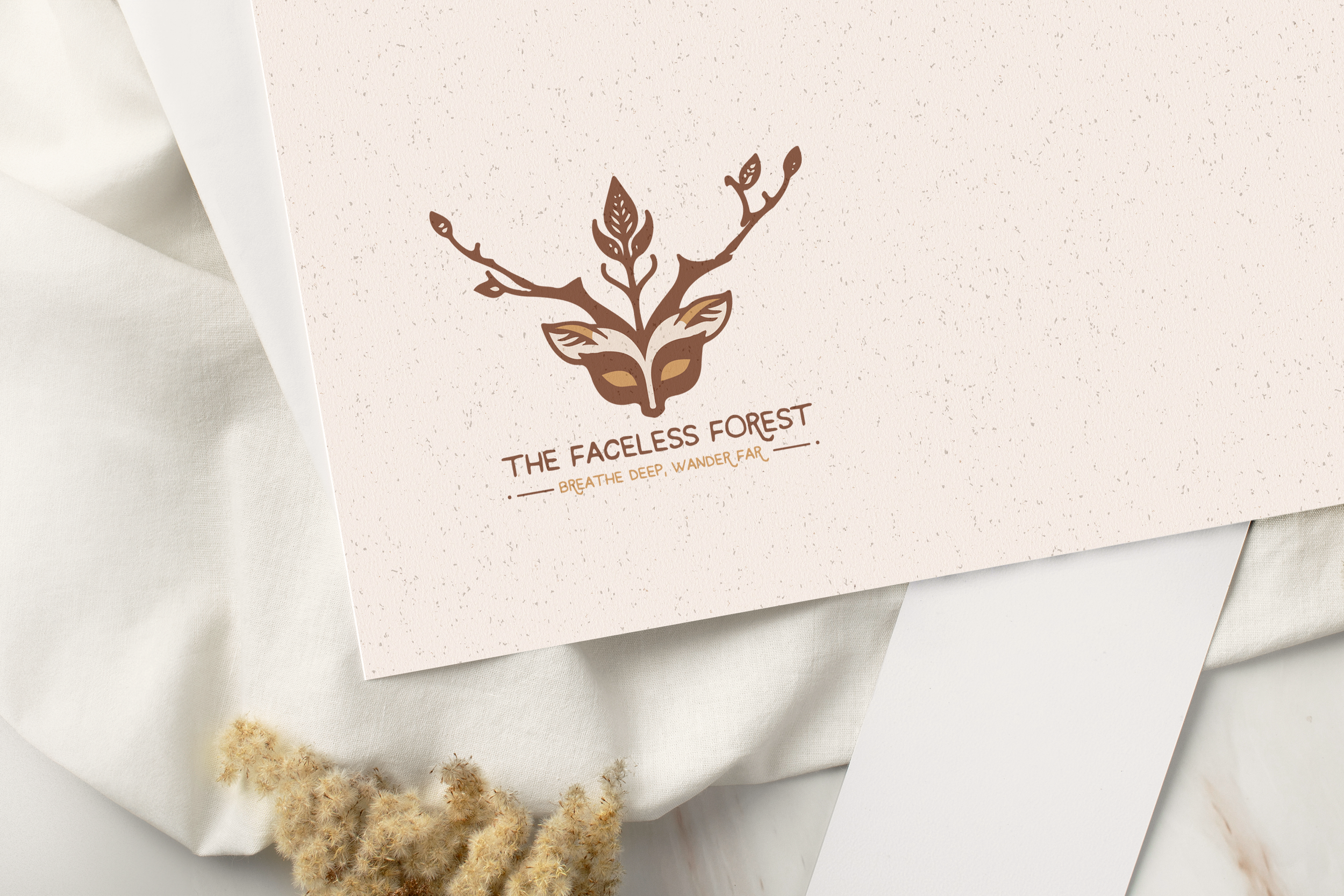 A textured beige paper with a logo of a stylized tree and face integrated into it, along with the text 'The Faceless Forest' and the slogan 'Breathe Deep, Wander Far' underneath.