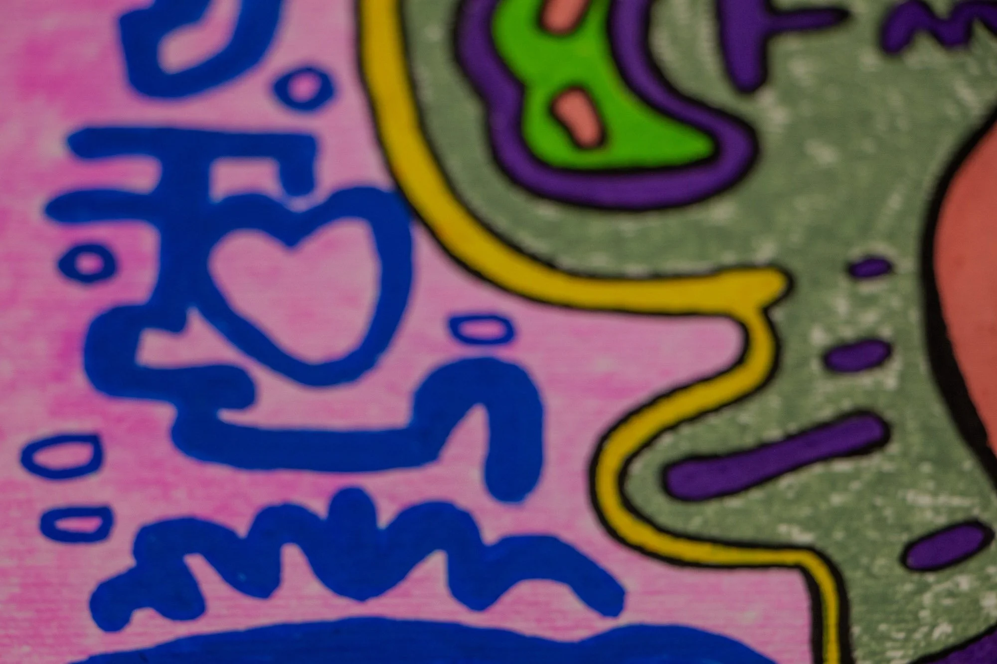 Unseen Signifiers 007 detail: shallow-focus close-up of a blue heart-like symbol on the pink background, meeting the yellow contour line and olive-green central field.