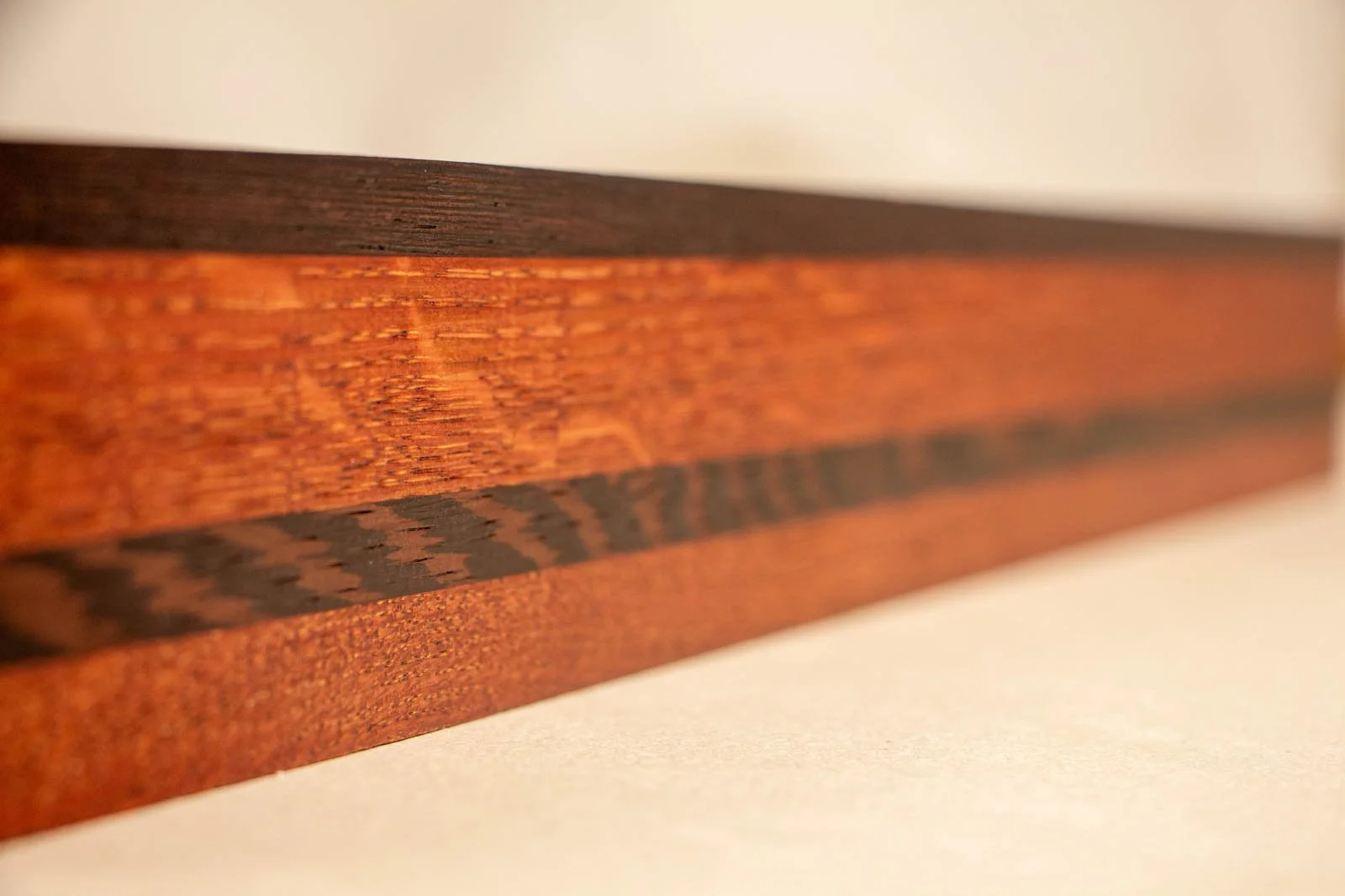 Formless Equation 004 frame: perspective along the oak frame, wengé top edge and profile depth. figures in oak