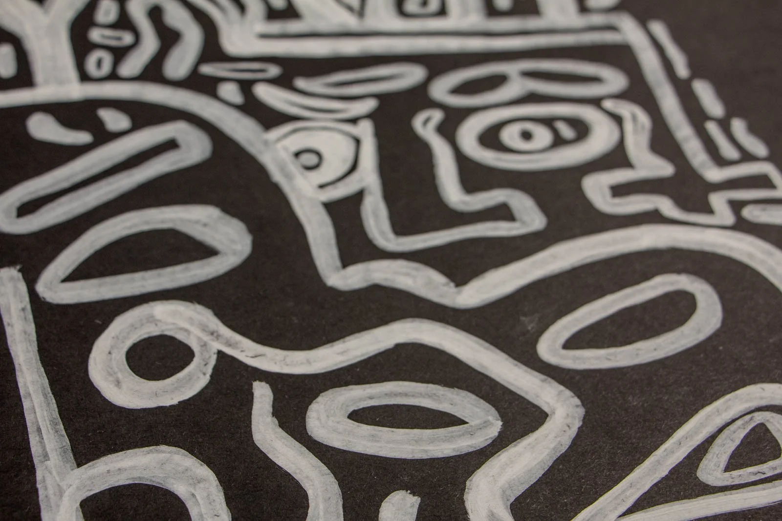 Metamorphic Entwining 001 detail: sinuous corridor of lines with bead-like ovals and leaf forms, rhythmic flow, white ink on black paper