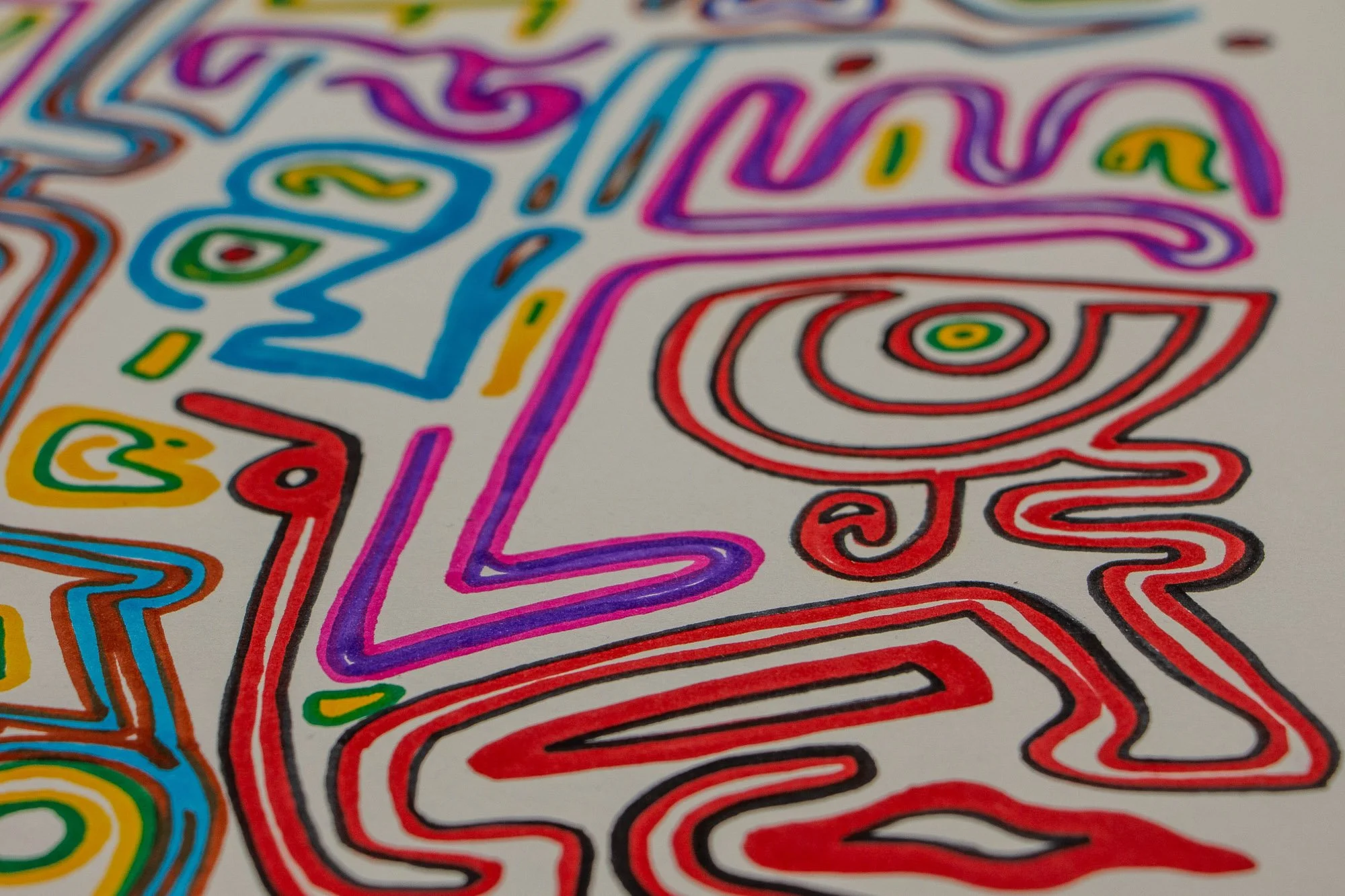 Eclipsing Gravitas 001 detail: close-up of a blue face-like figure with a concentric oval eye, pink and violet contours, and surrounding green, yellow, and red linear symbols on white paper.