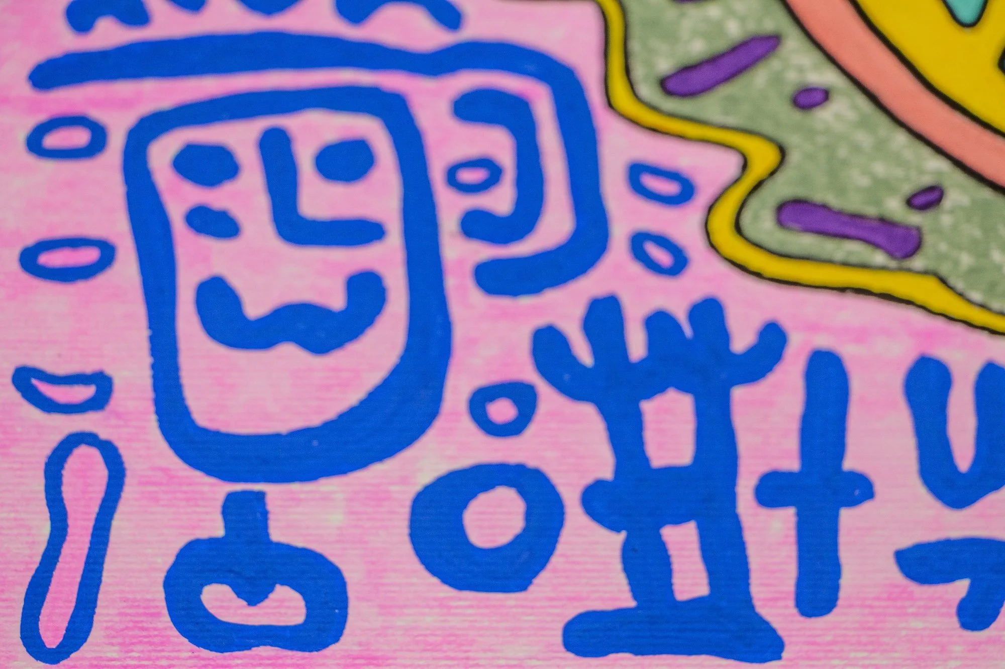 Unseen Signifiers 007 detail: close-up of blue linear symbols on the pink ground, including a face-like figure and surrounding marks beside the olive-green edge of the central form.